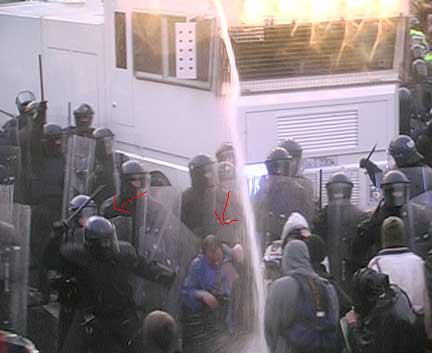 Riot cop hits EU summit protester