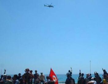 Police helicopter and crowd at G8 protests in Genoa