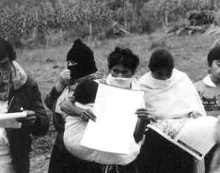 Women Zapatistas reading newspaper